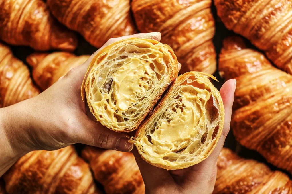 Freshly baked Tiong Bahru Bakery croissant with creamy filling and flaky golden layers in Singapore