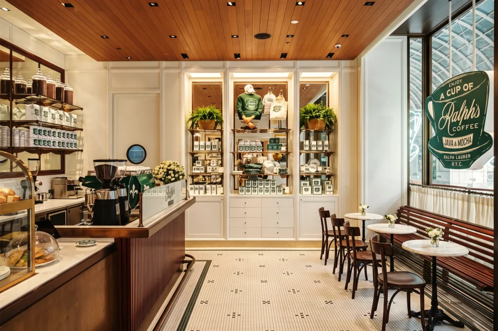 Ralph’s Coffee Singapore by Ralph Lauren featuring white tiled floors, green branding, and classic café seating with marble tables.