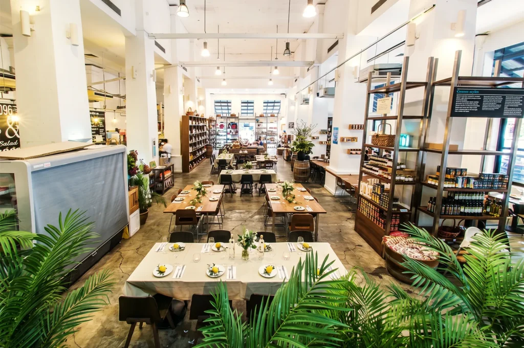 High-ceiling dining hall and gourmet retail store inside The Dempsey Project.